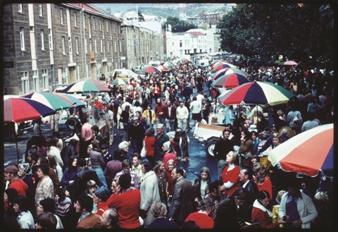 Salamanca Market Circa 1970. Salamanca place is lined with colourful umbrellas, and a crowd of people milling in the street.