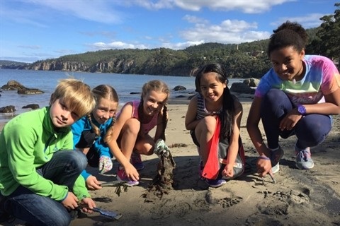 Children digging sand at a beach