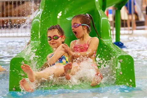 Kids having fun on the water slide at the Hobart Aquatic Centre.