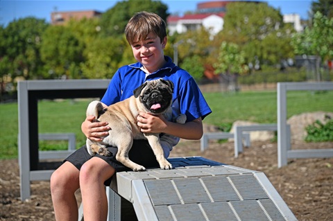 Young boy with his dog called Pug