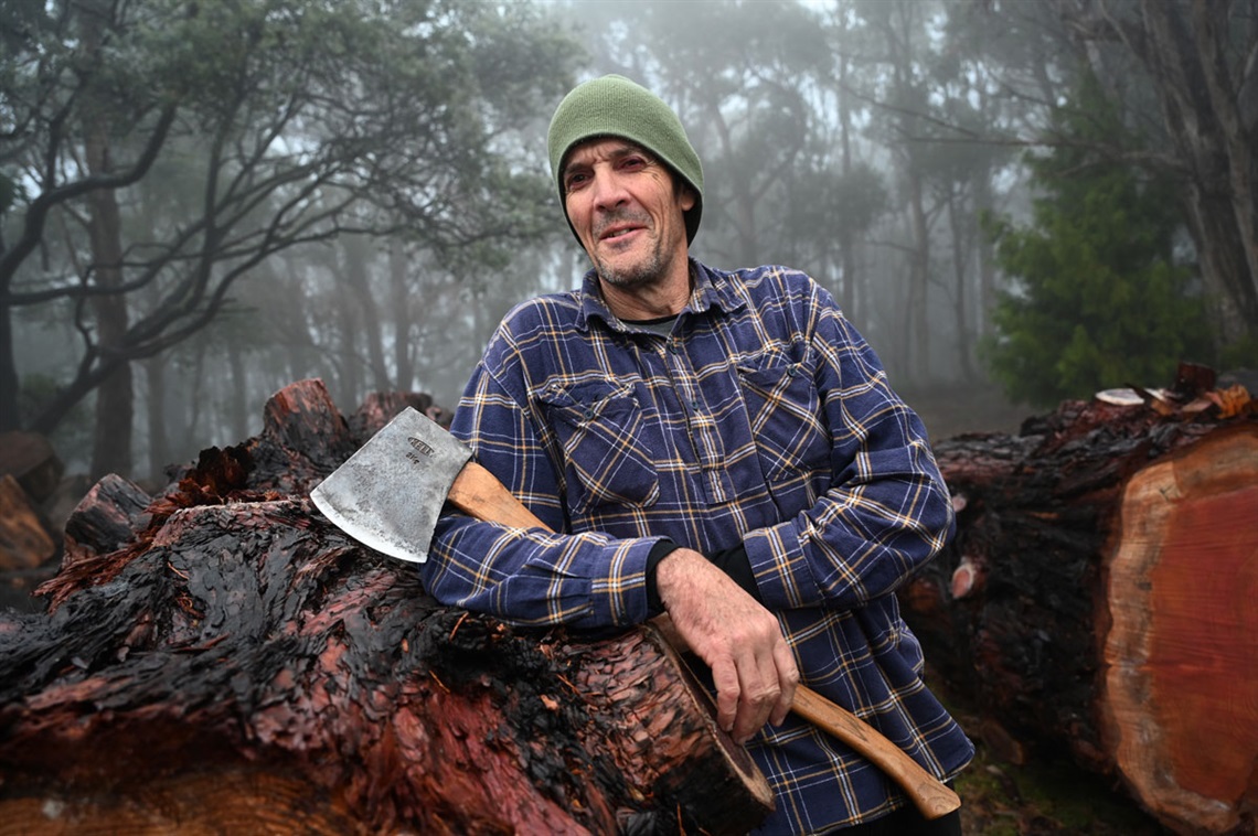 Andrew Evans next to a giant sequoia barrel.