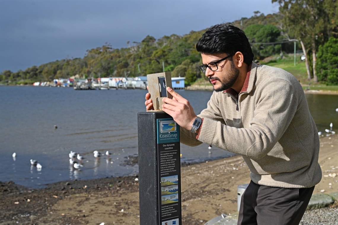 Man using CoastSnap station at Cornelian Bay