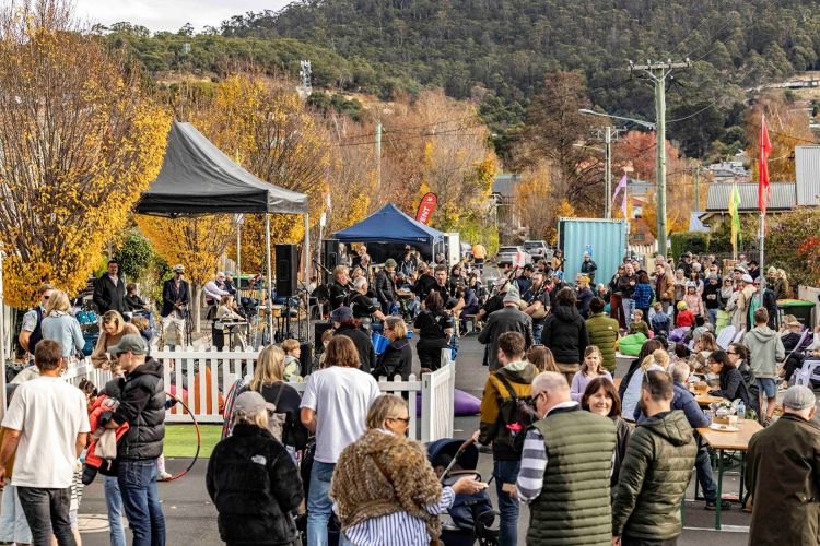 Neighbours enjoying Highland Pipe Music, circus activities, and BBQ at the West Hobart My Street party, June 2025