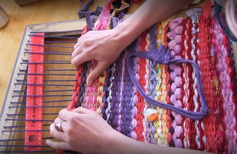 Image of a person doing tapestry at The Tip Shop